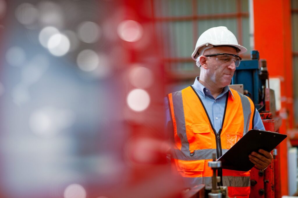 PCBU dressed in hivis and conducting a safety inspection in an industrial setting